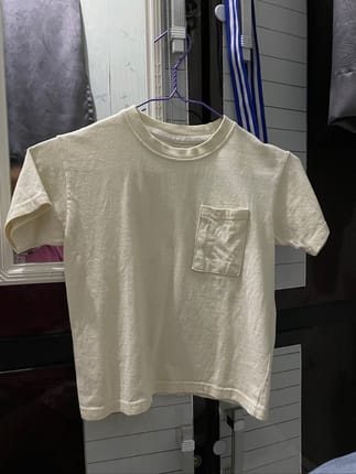 Kaos lengan pendek berwarna kuning pucat atau off-white