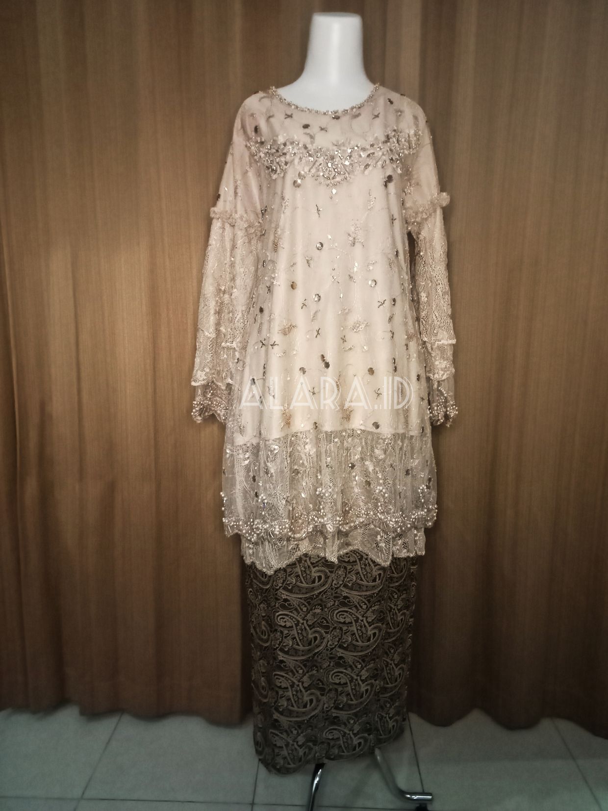 An engagement kebaya showered with beads